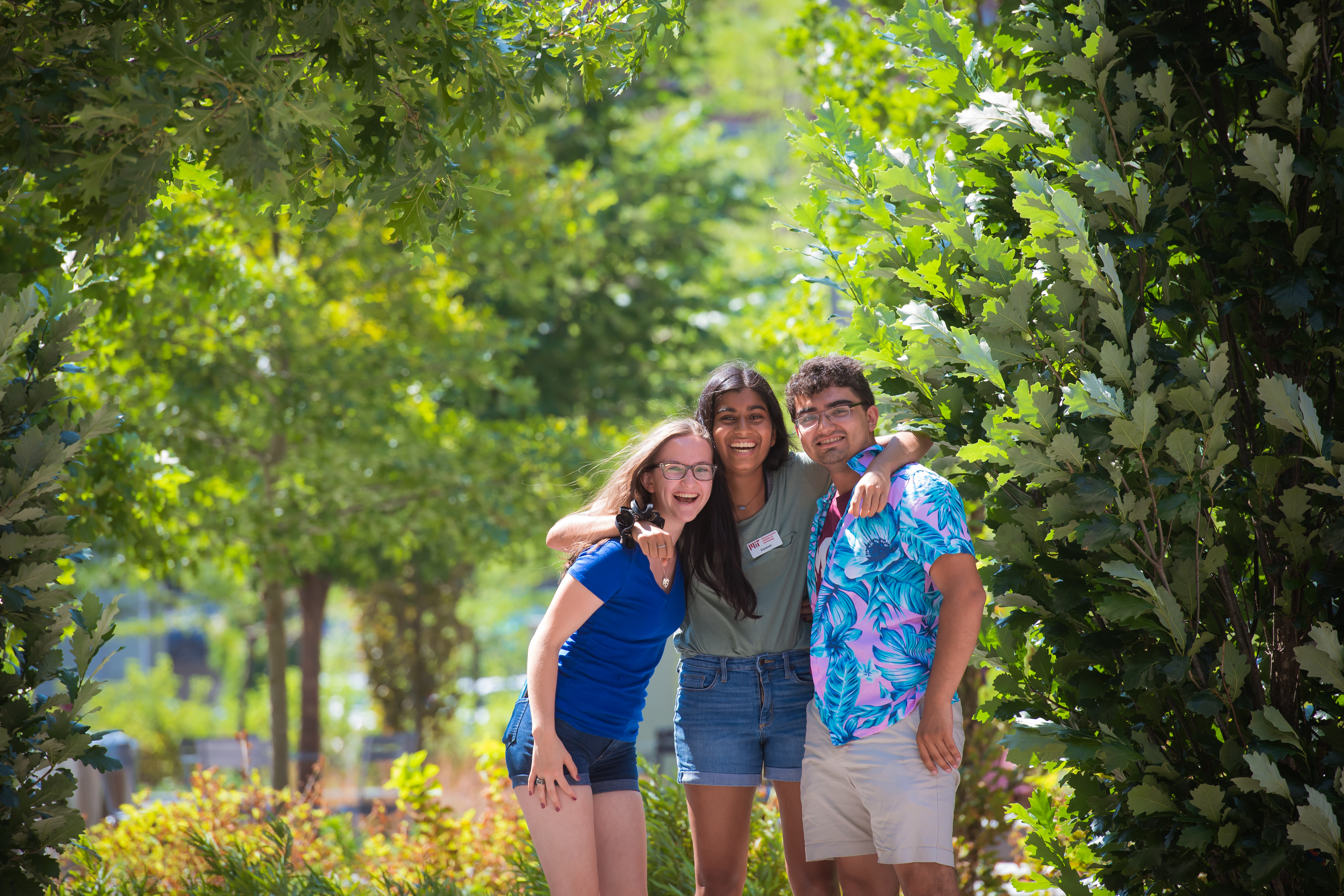 Undergraduate students smiling on MIT's campus.